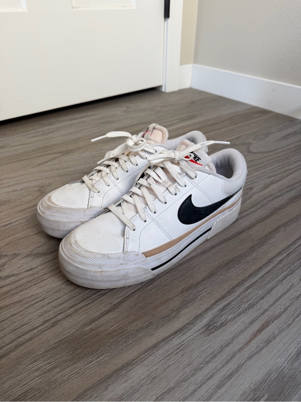 Nike Women’s White Sneakers with Black Swoosh and Tan Accent